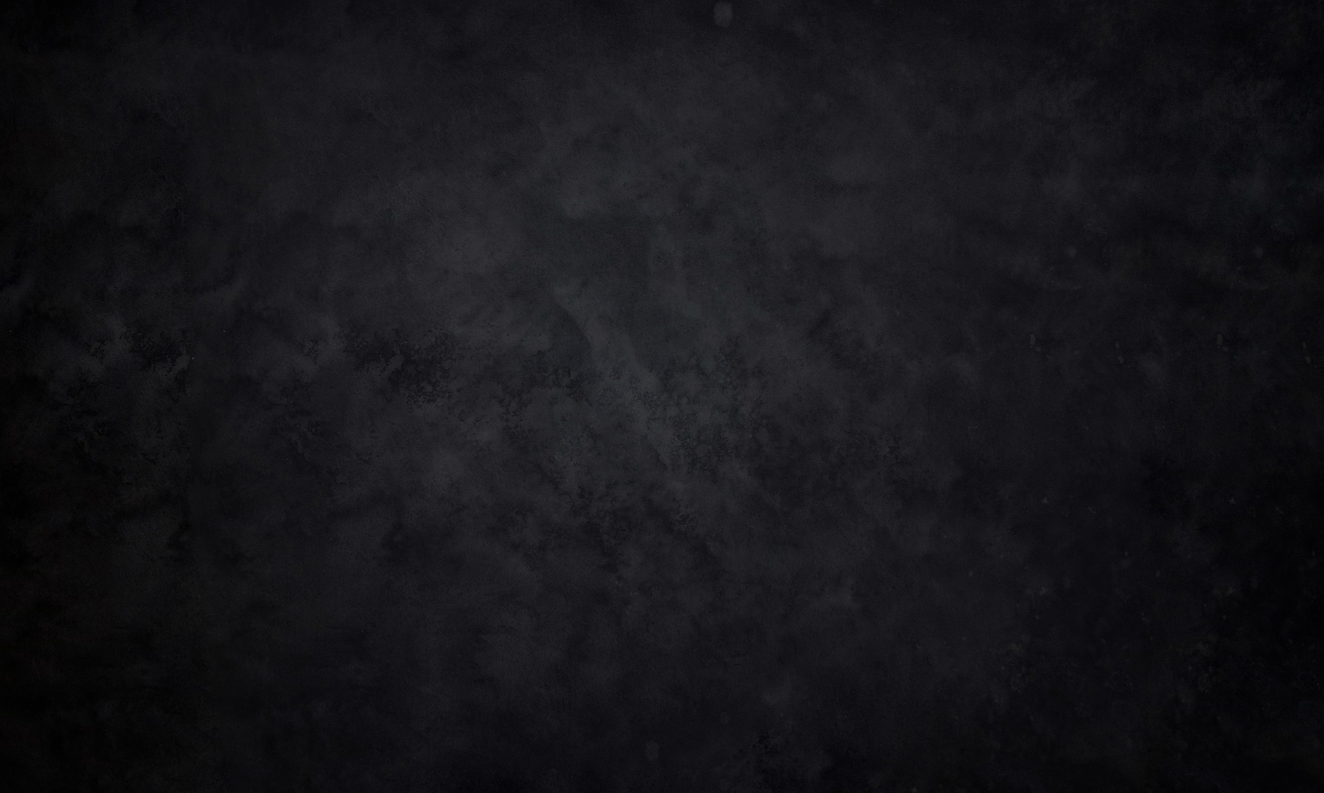 Dark textured abstract background with subtle gradients.