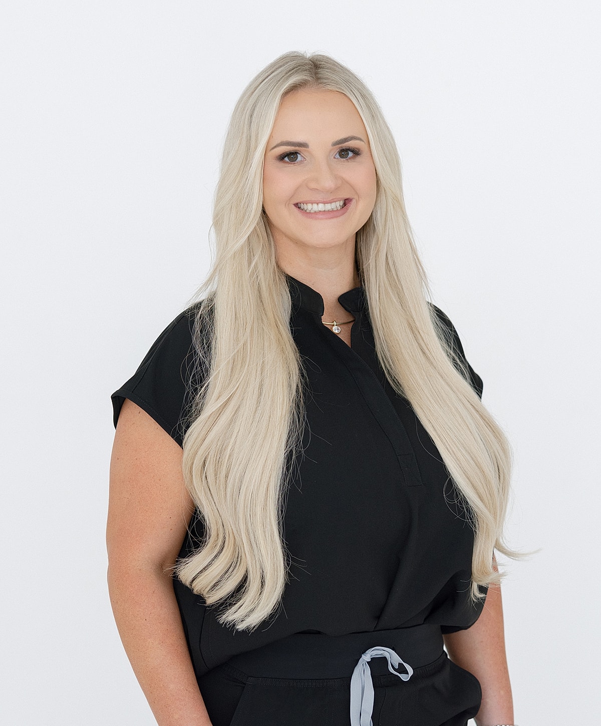 Smiling woman with long blonde hair, wearing black.