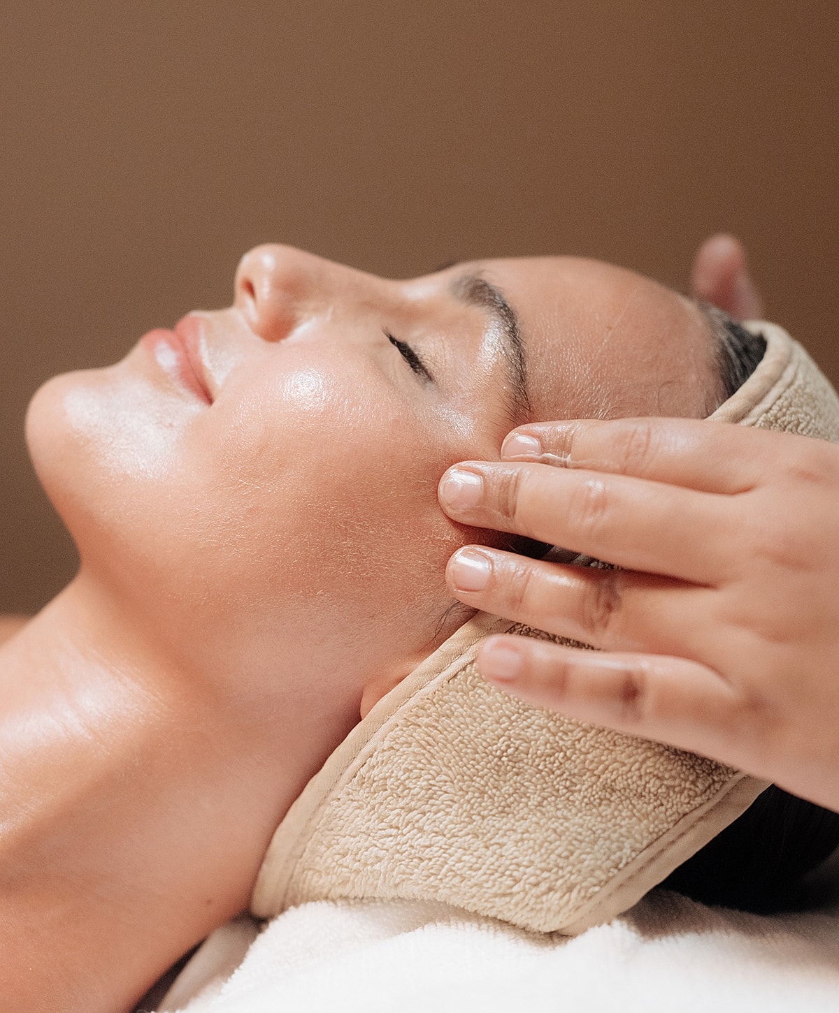 Woman receiving a relaxing facial treatment.