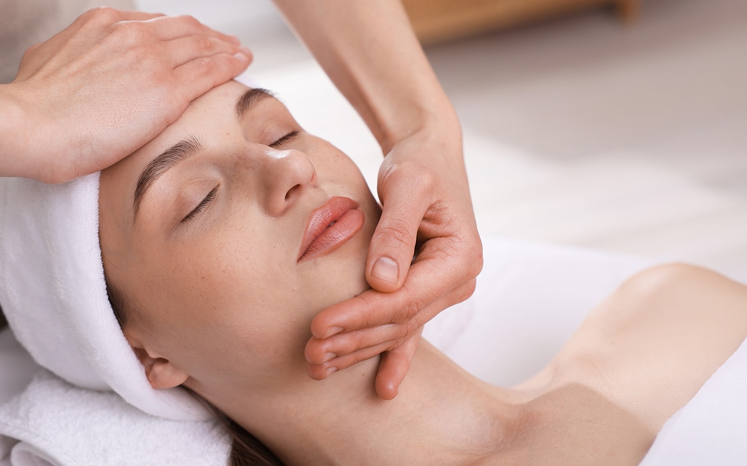 Facial massage therapy in a serene setting.