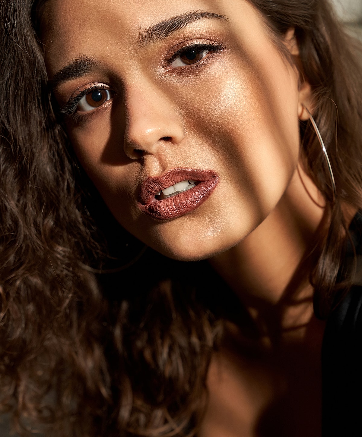 Close-up portrait of a woman in soft lighting.