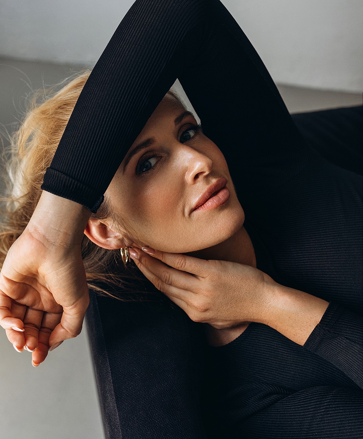 Woman resting with hand on her face.