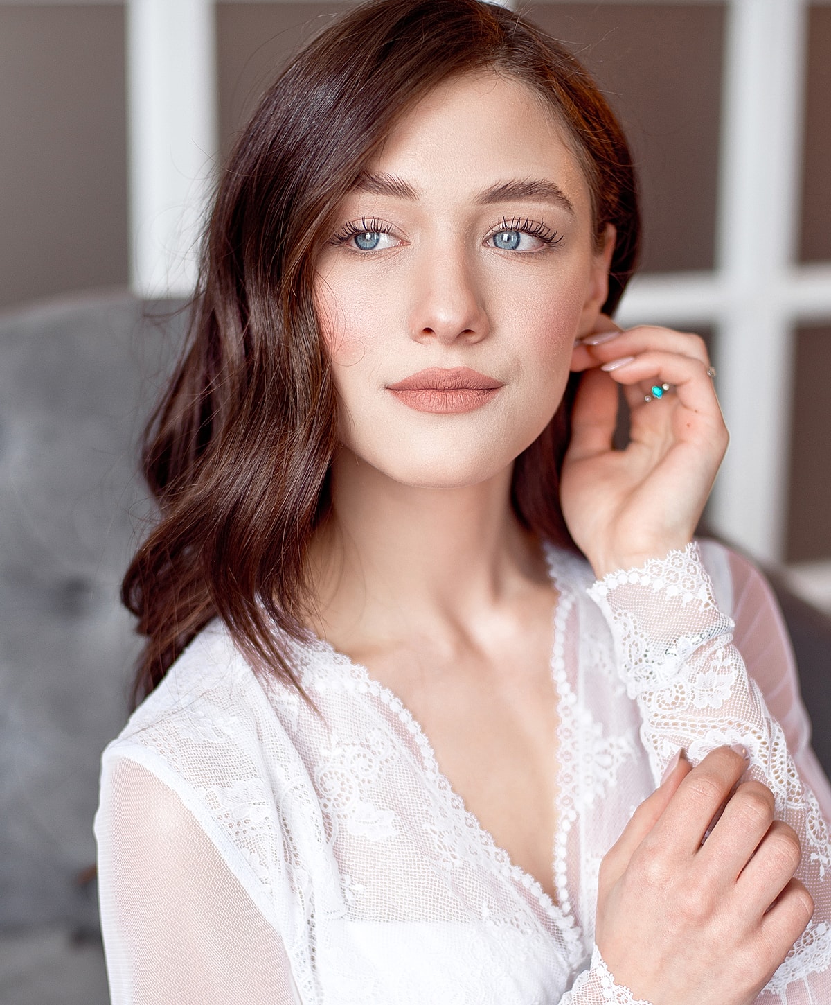 Woman in white attire with elegant pose.