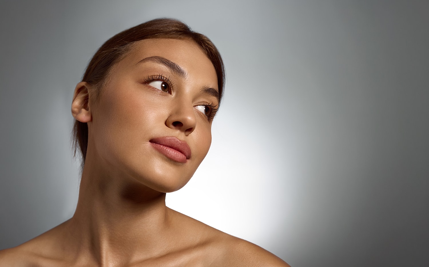 Woman with natural makeup and soft lighting.