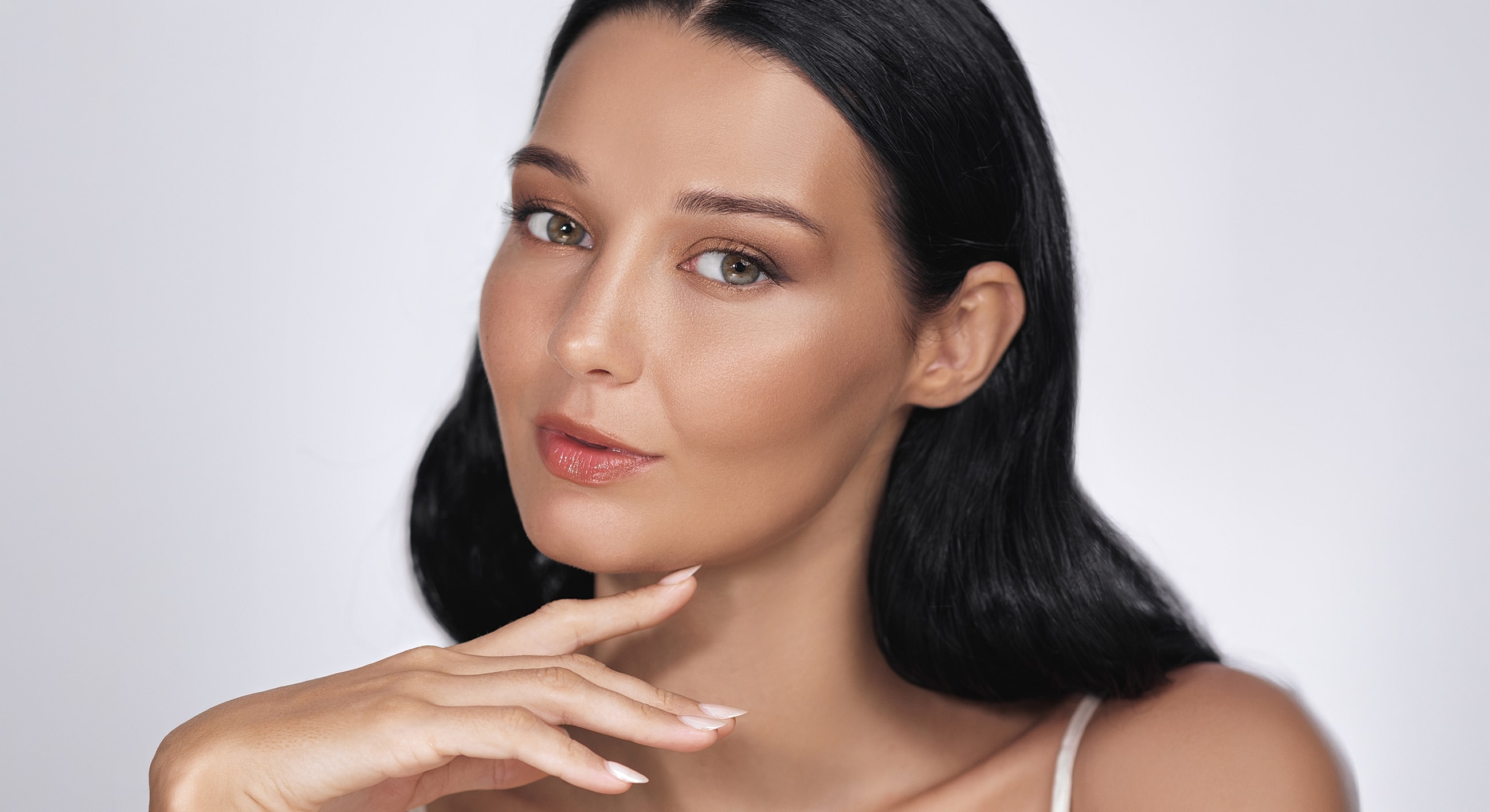 Woman with elegant makeup and thoughtful expression.