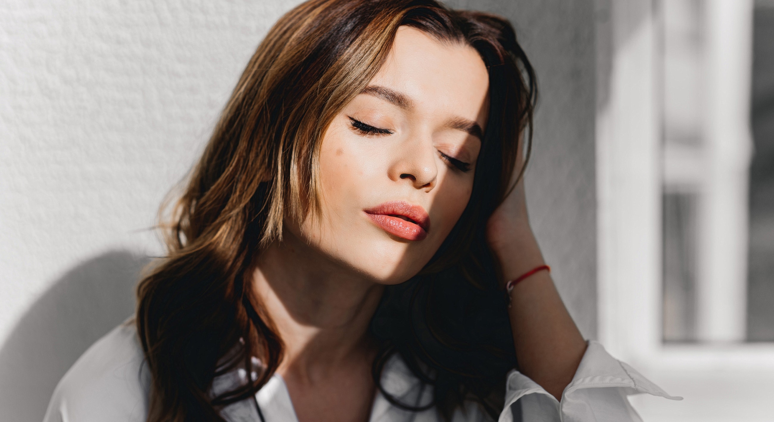 Woman with closed eyes and soft expression.